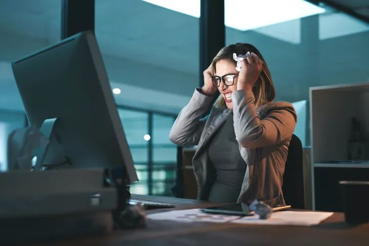 Woman at work looking composed but exhausted inside
